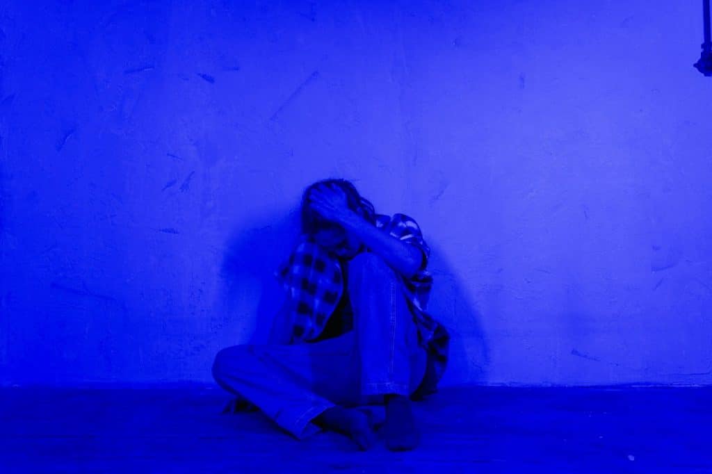 A man sitting alone at the floor