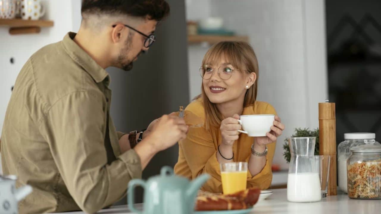 Couple enjoying morning coffee together with warmth and kindness.