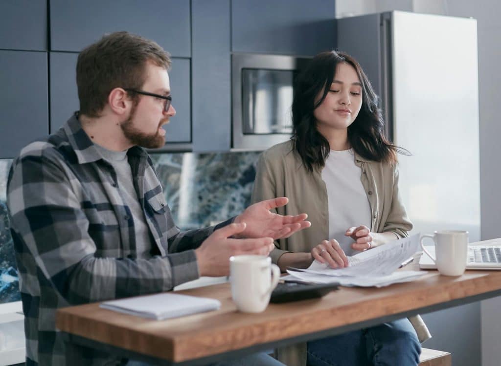 A man asking a woman about finances