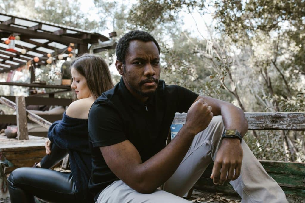 A man and woman sitting and facing away from each other