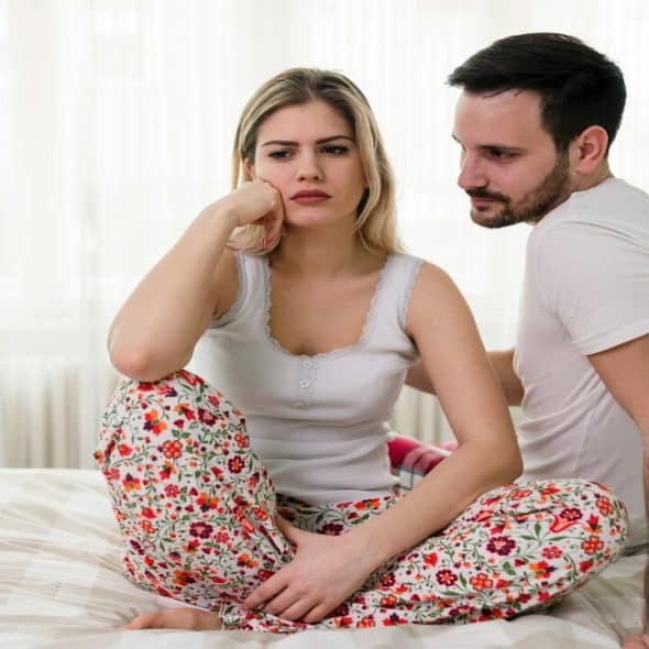A couple fighting in bed