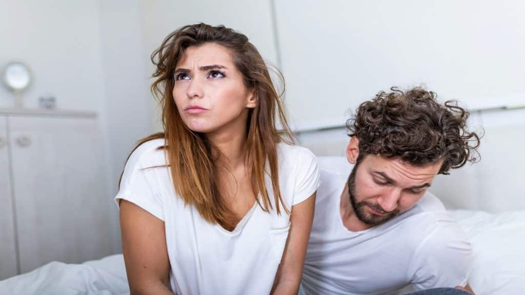 A couple fighting in bed