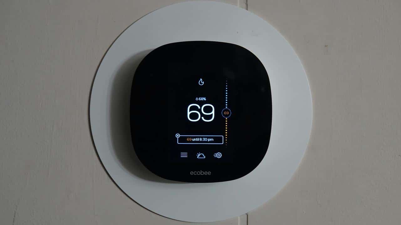 A smart thermostat displaying a temperature of 69 degrees.