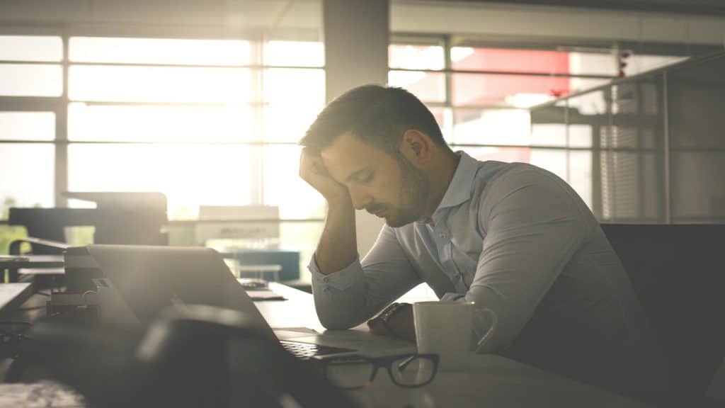 A man looking tired at work