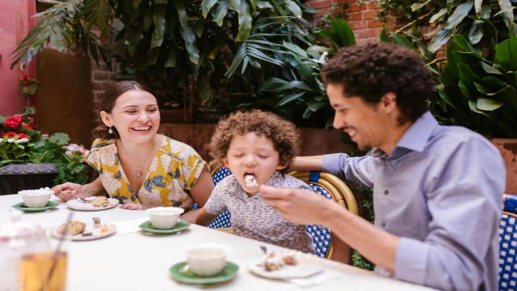 Parents feeding their kid