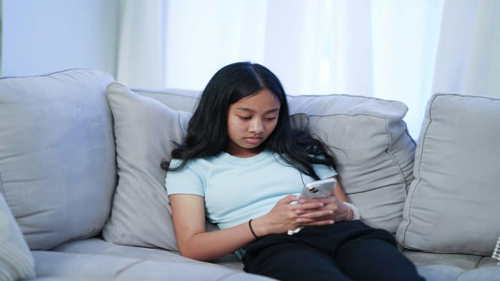A kid using her phone