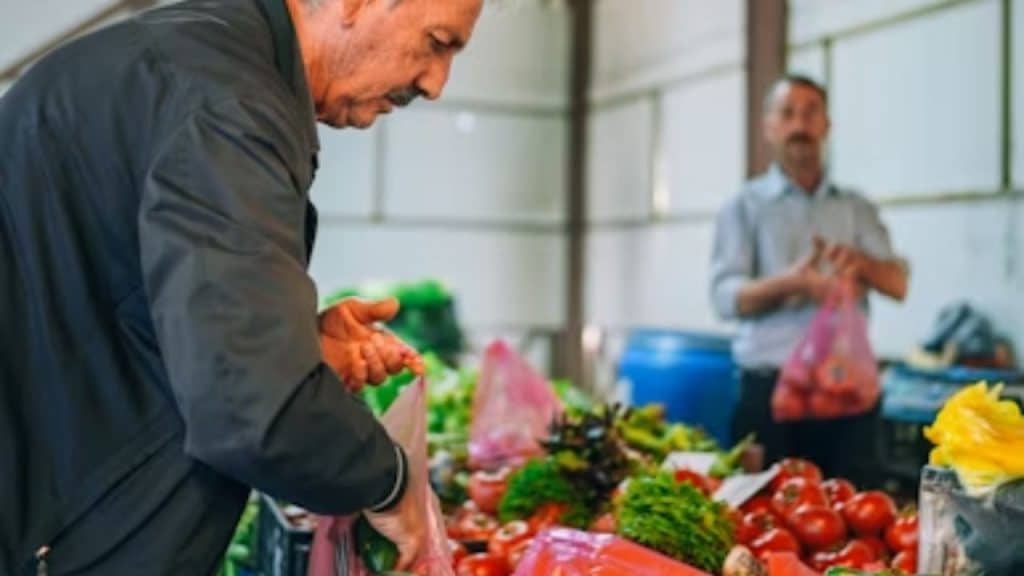 A man choosing fresh produce at the grocery store