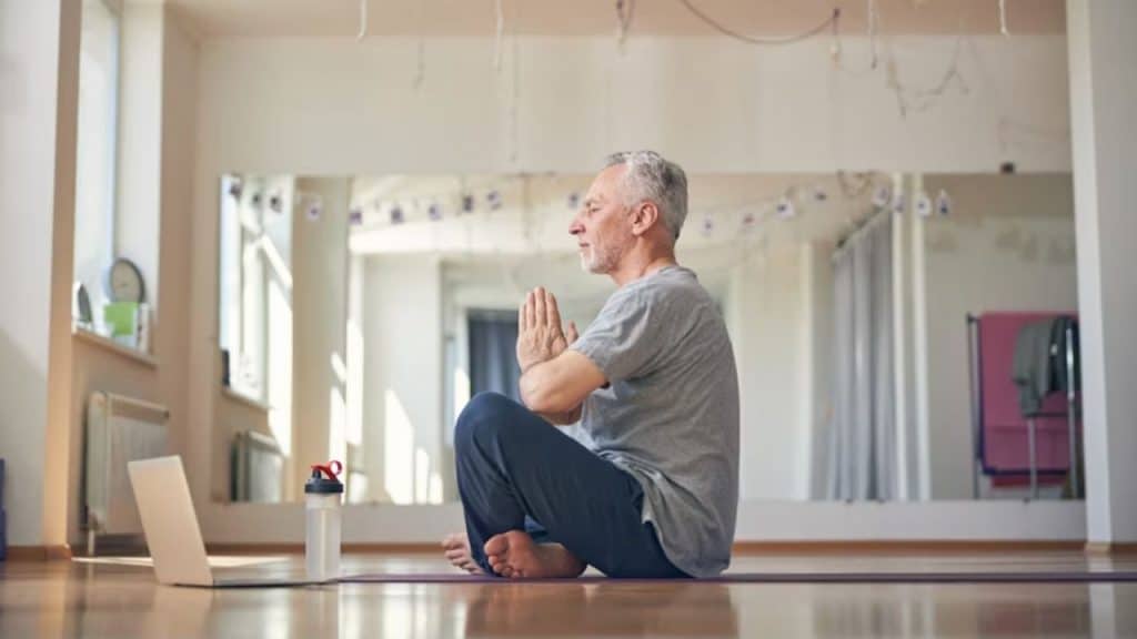 A man meditating in his living room