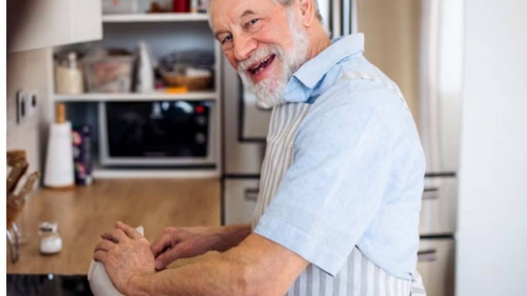A man portioning food into small containers