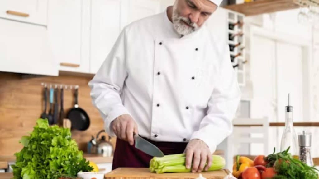 A man smiling while preparing a fresh meal for himself