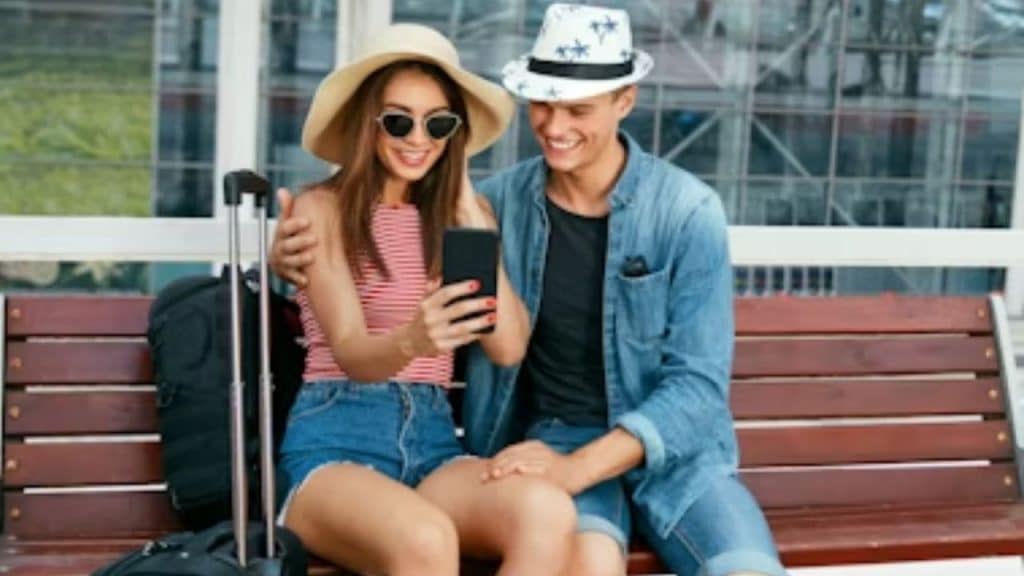 A couple taking selfie, keeping them busy while waiting calmly at the station