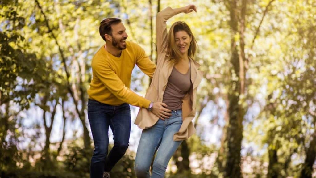 A couple laughing together during a casual walk