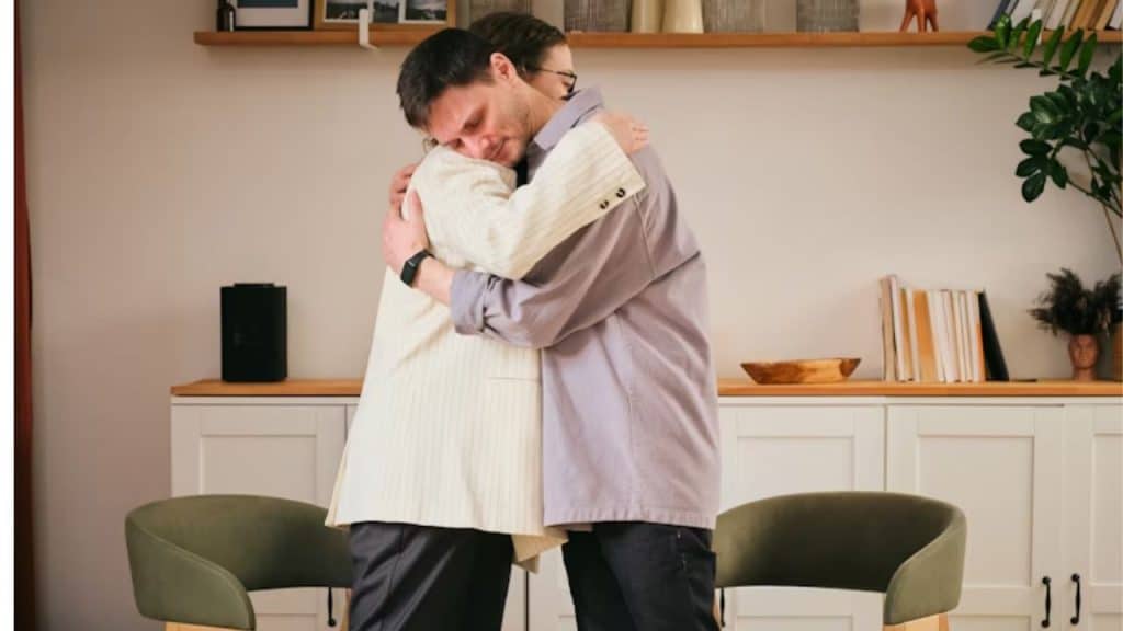 A man comforting his partner with a supportive embrace