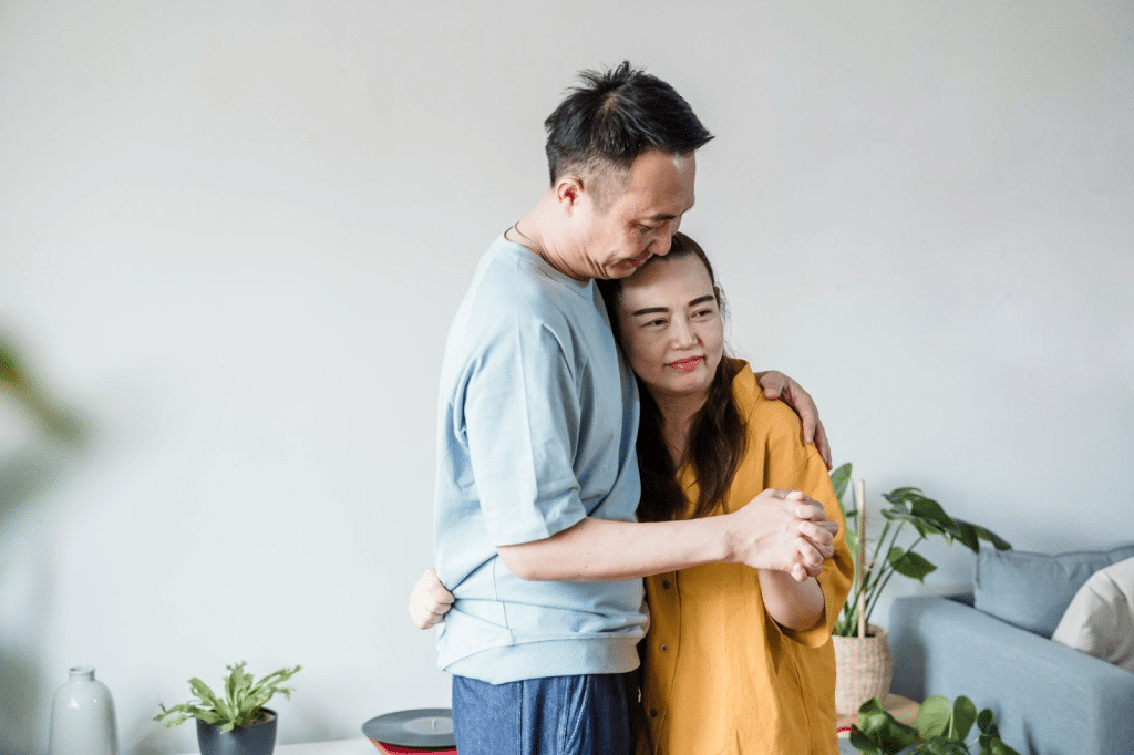 A husband hugging his wife