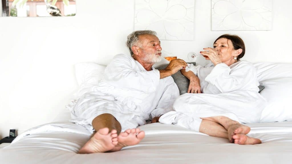 A mature couple having wine at a hotel