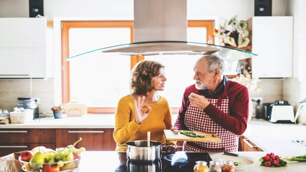 A mature couple cooking together