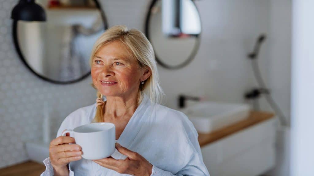 A mature woman having coffee by herself 