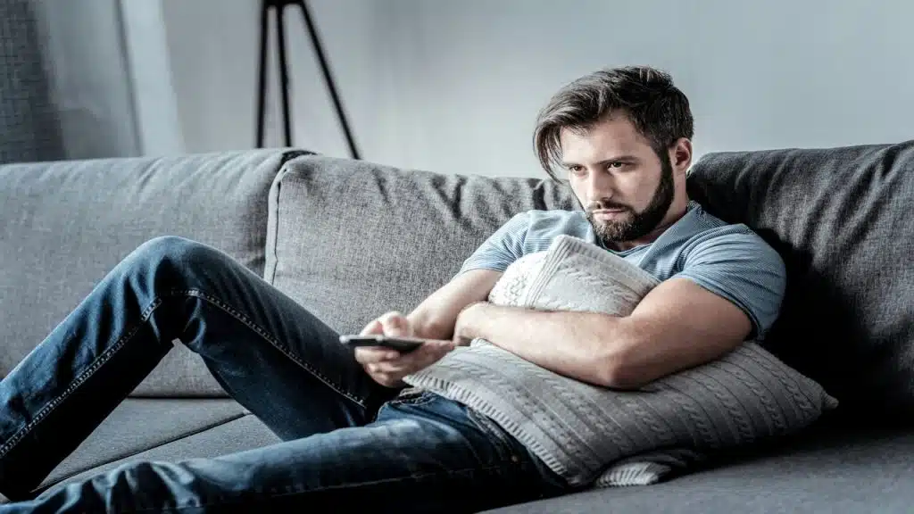 A man looking sad at home and alone