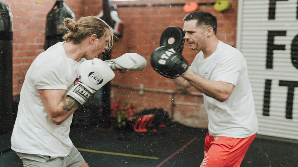 Two men sparring in a boxing gym