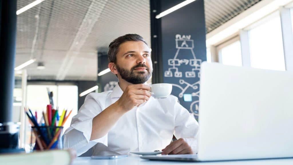 A man drinking coffee at work