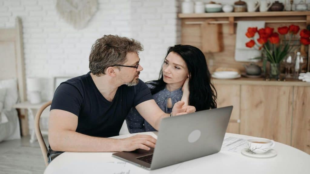 A couple using their laptop at home