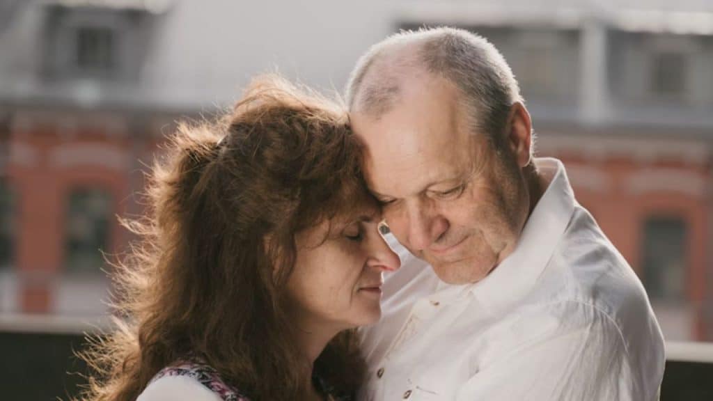 A couple reconciling with a hug after an argument.