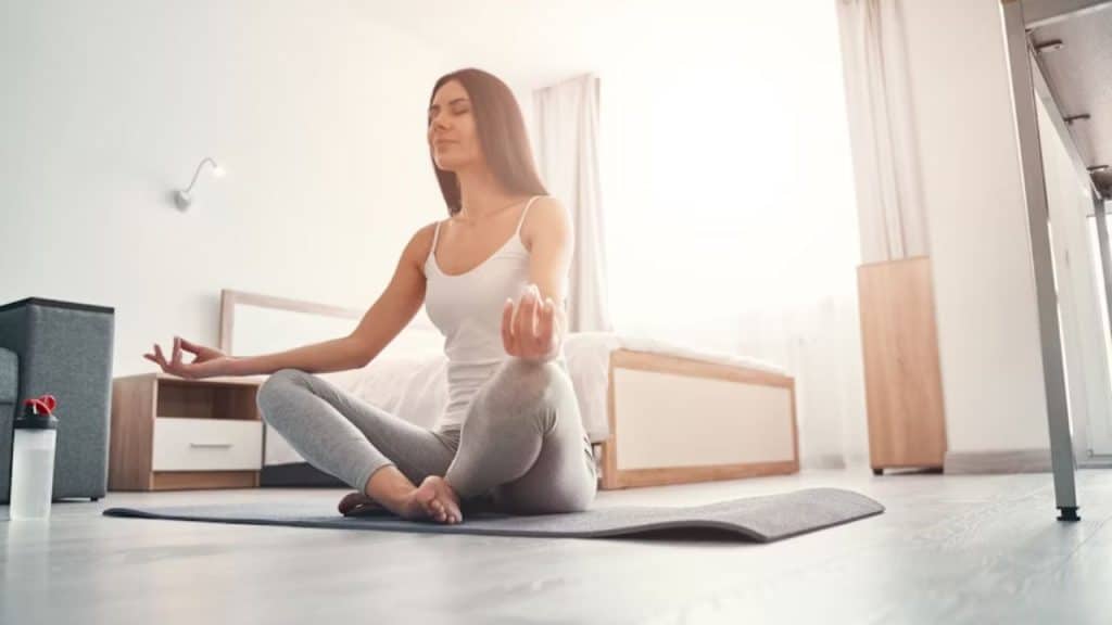 Woman practicing yoga at home