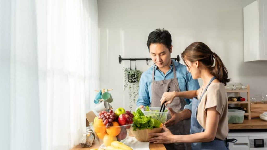 Couple preparing fresh vegetables together in the kitchen