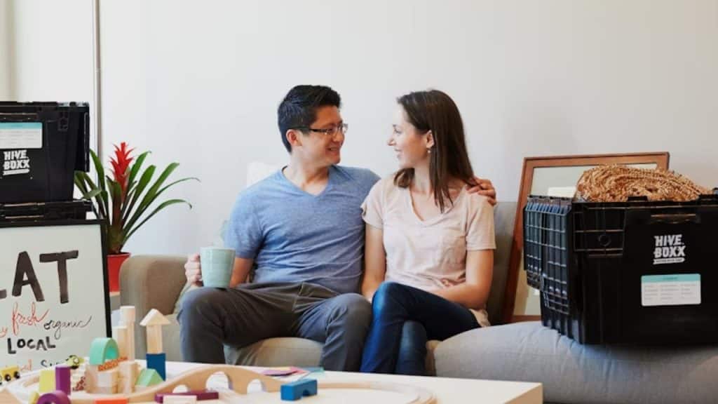 Couple sitting on couch in deep supportive conversation
