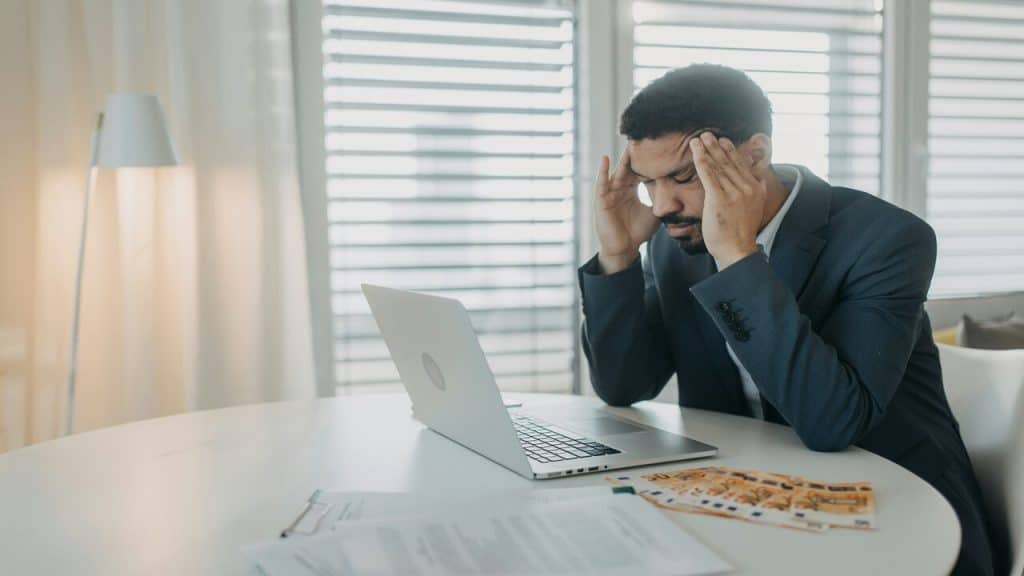 A man looking stressed while working