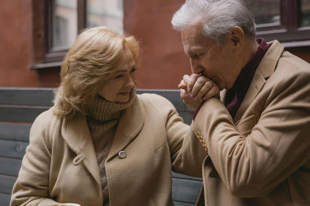 A man kissing a woman’s hand