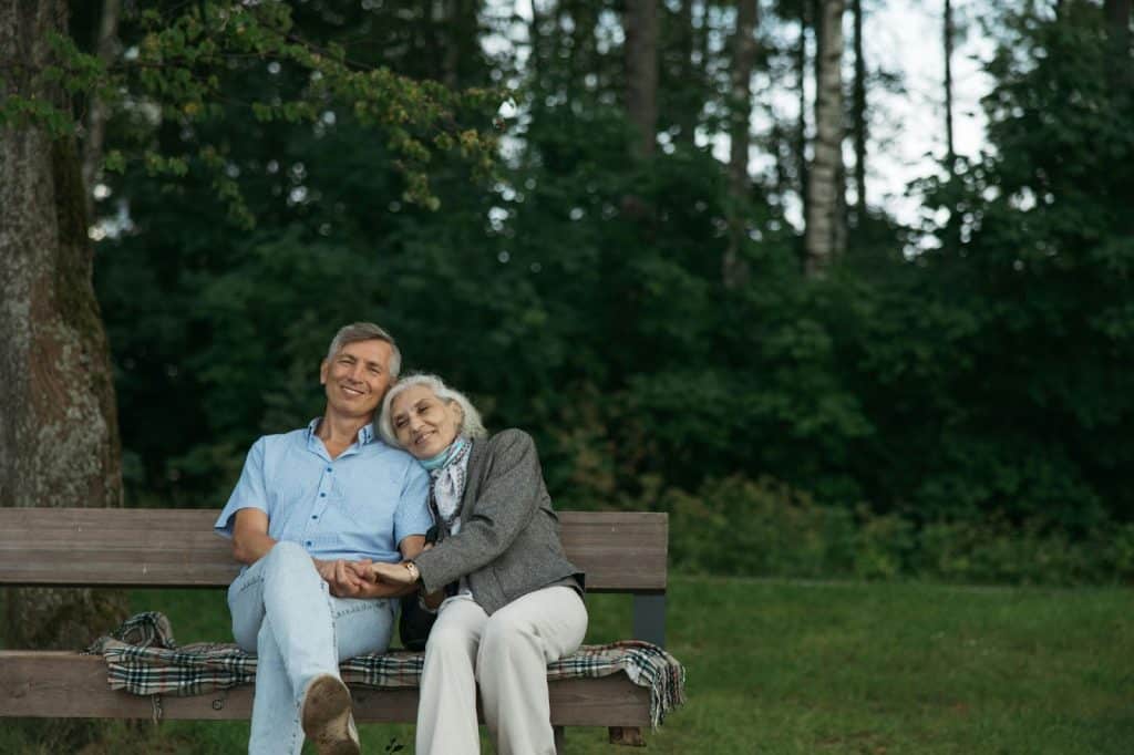 A man and woman sitting at the bench