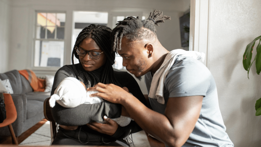 A couple taking care of their baby