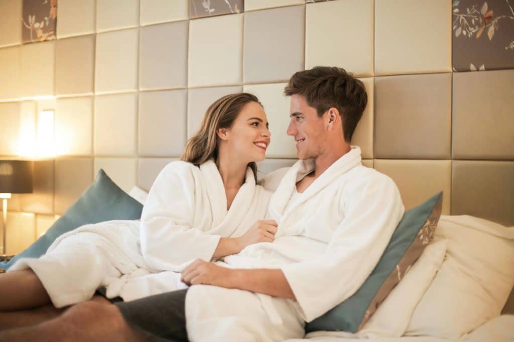 A man and woman at the bed