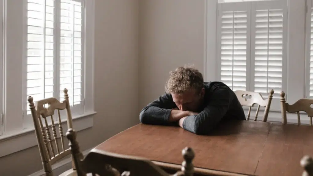 A man looking sad at home