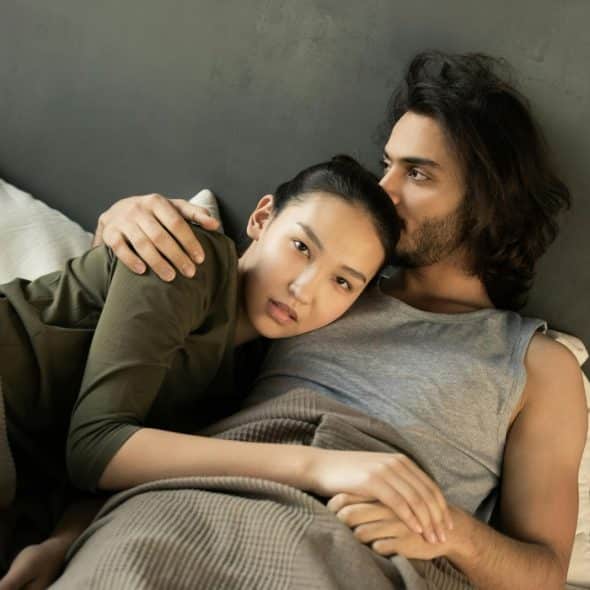 A man kissing a woman’s head