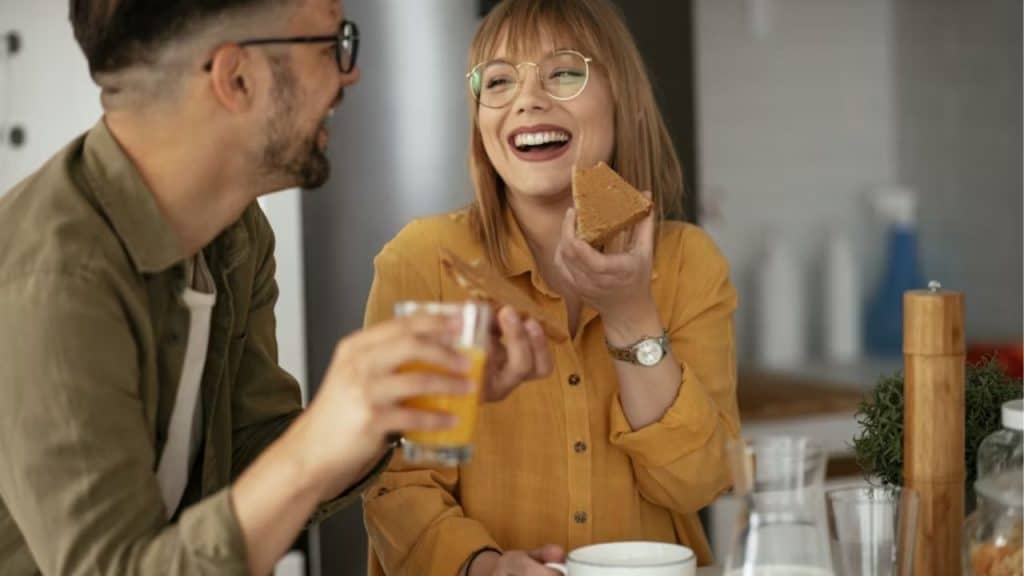 Couple talking casually with drinks, laughing and relaxed