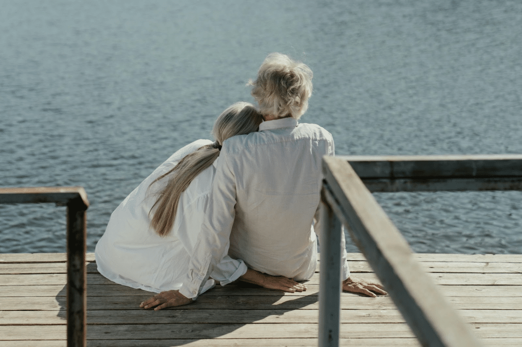 A man and woman looking at the lake