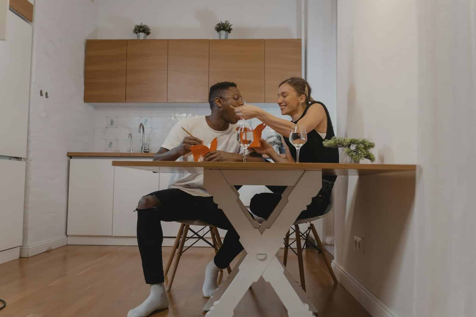 A man and woman having dinner together.