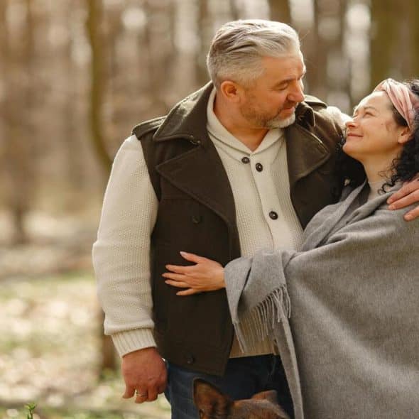 A couple hugging in the woods
