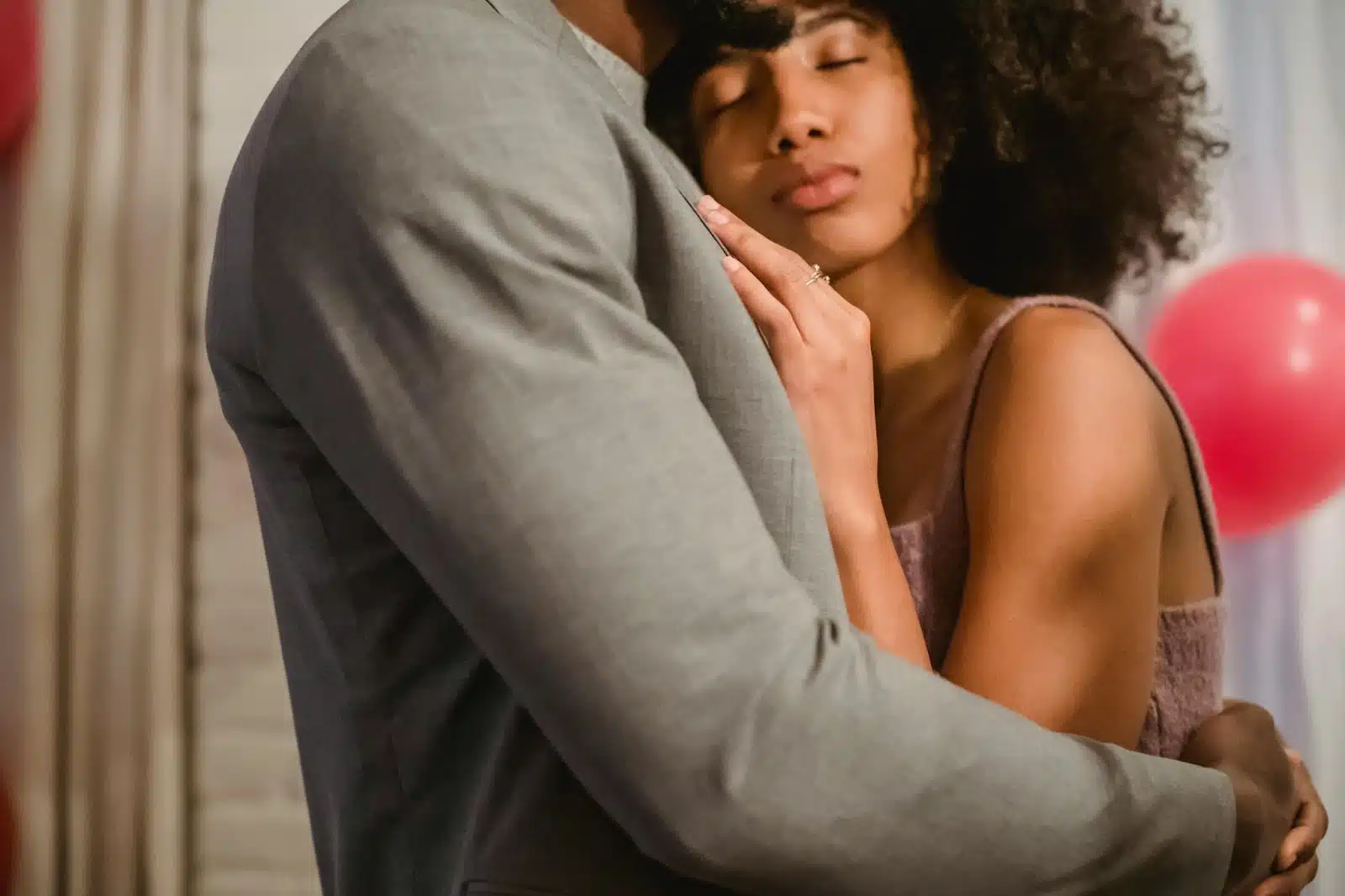 A man and woman hugging each other.