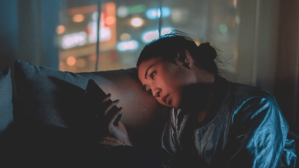 A woman looking sad while on her phone