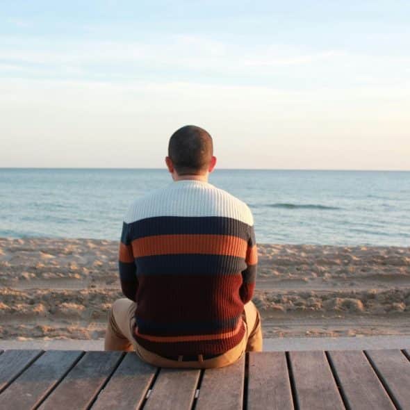 A man facing the ocean