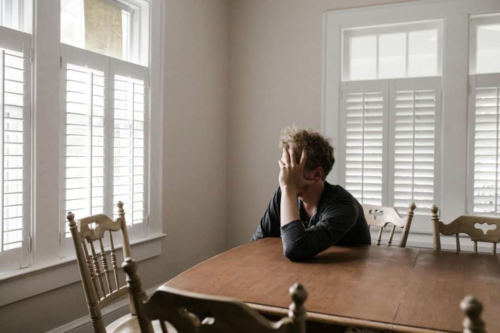A man alone sitting and thinking 