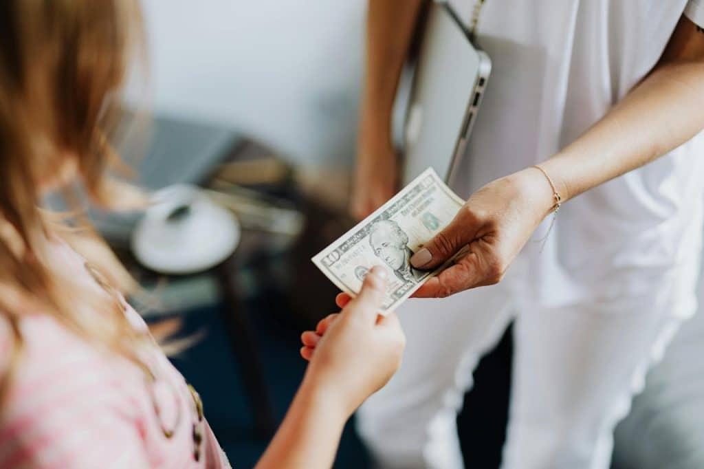 A man giving a money to woman