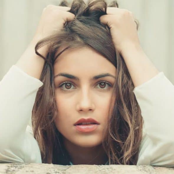 A woman holding her head looking frustrated