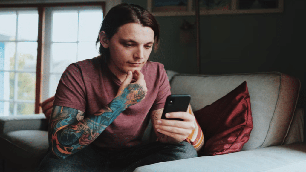 A man looking sad while texting