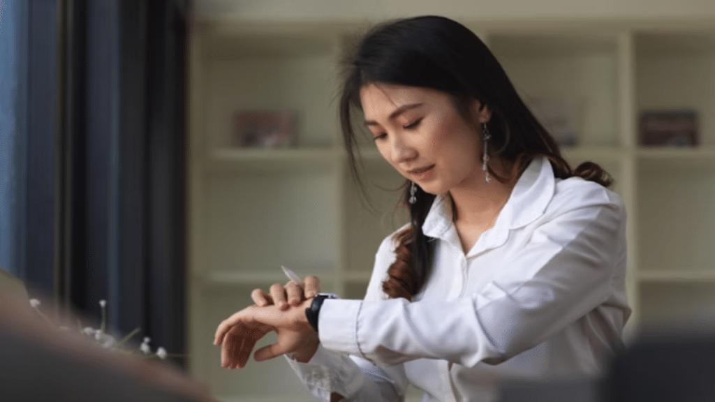 A woman checking the time at home