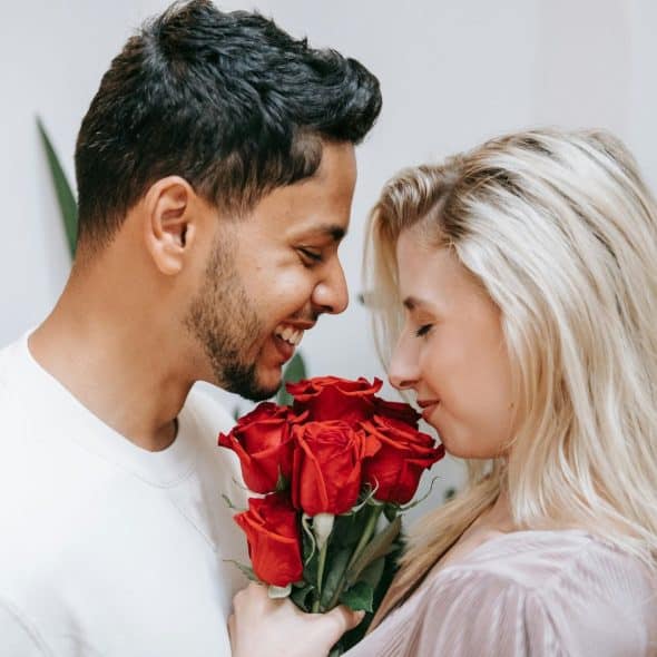 A man giving a rose to a woman