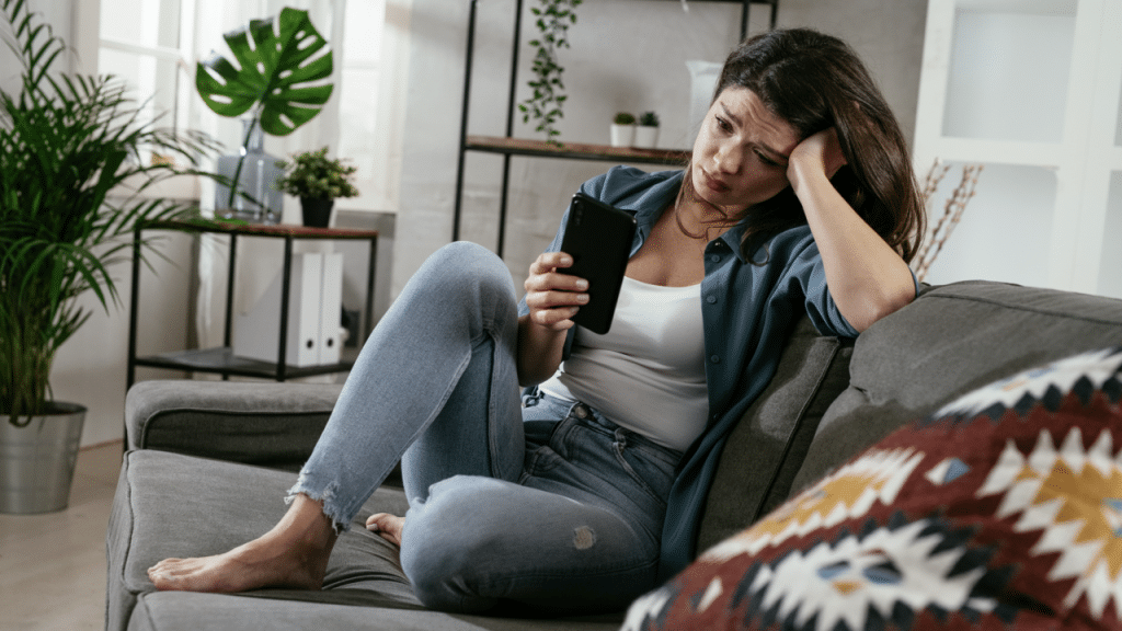 A woman crying while texting